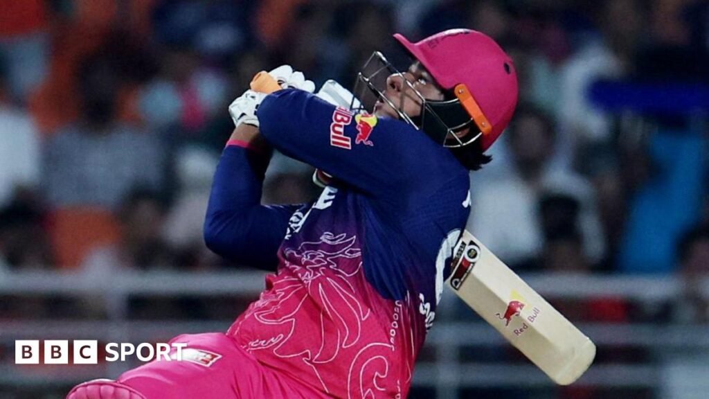 Vaibhav Sooryavanshi holding a cricket bat over his shoulder