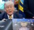 Donald Trump hols up a rendered image of the UFC's White House event